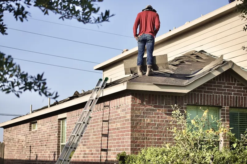 Professional roofer working on a residential roof in Esther Short